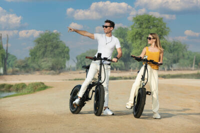 Biyiy - a couple riding a bike in a Dubai desert