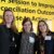 Photo taken during the Together25Ensemble conference featuring three women posing in front of a yellow background